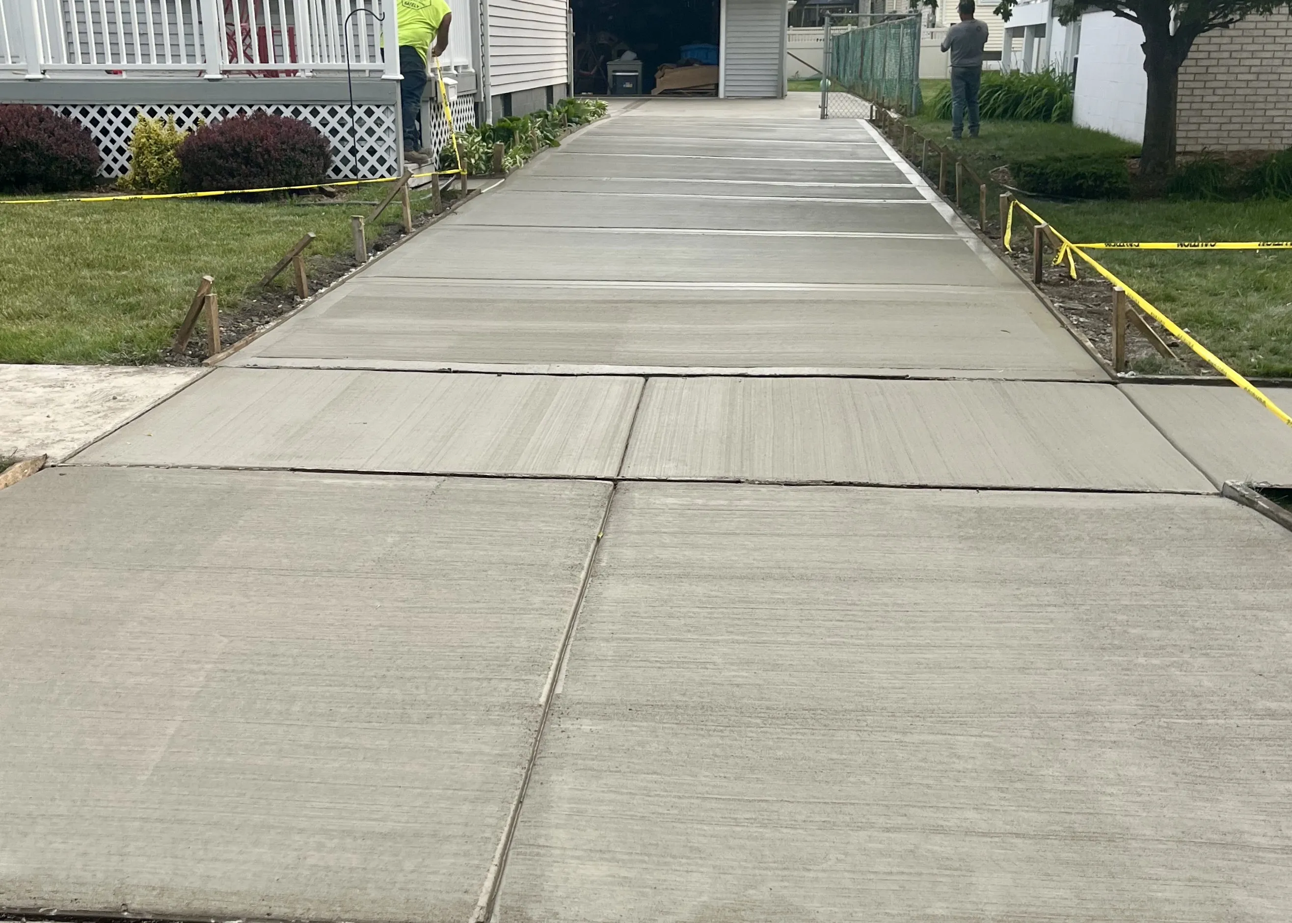 Freshly poured concrete sidewalk with clean edging.