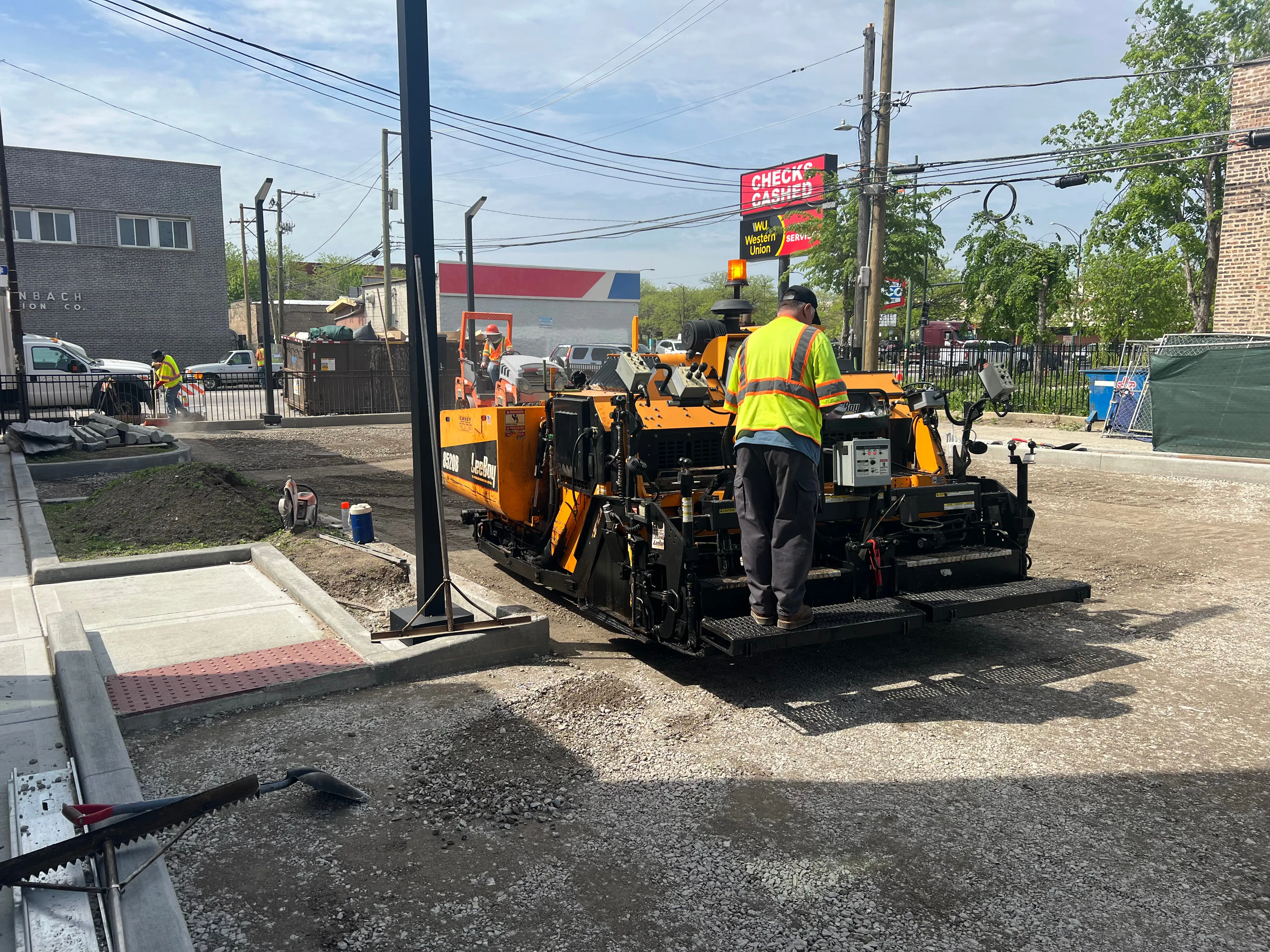 Aggregate base being graded and compacted at a job site.